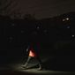 A woman lights up the road with a flashlight during blackout in Kyiv, Ukraine, Friday, Feb. 3, 2023. (AP Photo/Evgeniy Maloletka)