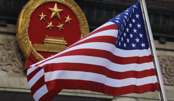 An American flag is flown next to the Chinese national emblem during a welcome ceremony at the Great Hall of the People in Beijing, Nov. 9, 2017. Secretary of State Antony Blinken has postponed a planned high-stakes weekend diplomatic trip to China as the Biden administration weighs a broader response to the discovery of a high-altitude Chinese balloon flying over sensitive sites in the western United States, a U.S. official said Friday.(AP Photo/Andy Wong, File)