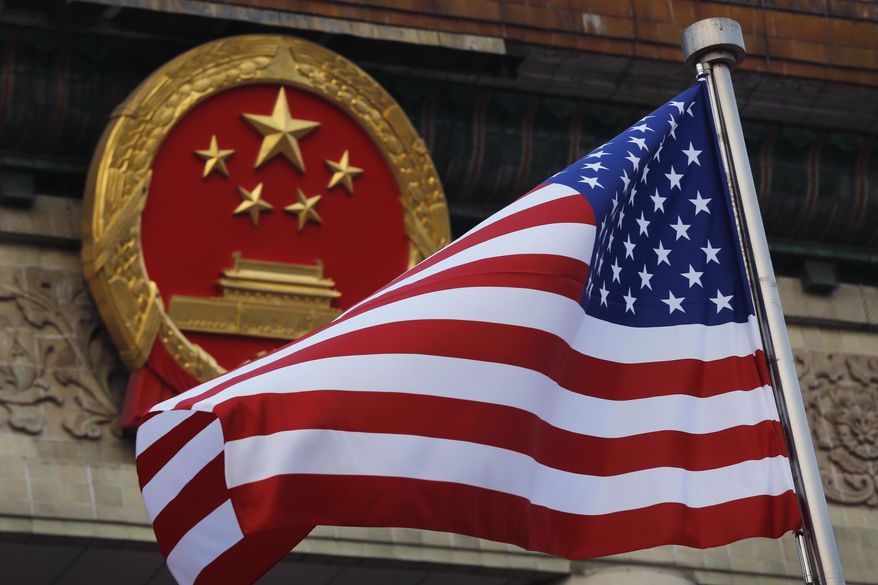 An American flag is flown next to the Chinese national emblem during a welcome ceremony at the Great Hall of the People in Beijing, Nov. 9, 2017. Secretary of State Antony Blinken has postponed a planned high-stakes weekend diplomatic trip to China as the Biden administration weighs a broader response to the discovery of a high-altitude Chinese balloon flying over sensitive sites in the western United States, a U.S. official said Friday.(AP Photo/Andy Wong, File)