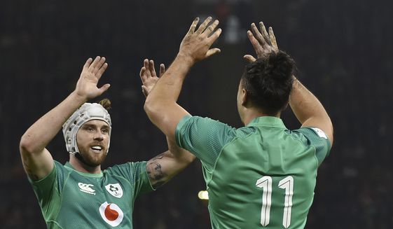 Ireland&#x27;s James Lowe, right, celebrates with teammate Mack Hansen after scoring a try during the Six Nations rugby union international match between Wales and Ireland at the Principality Stadium in Cardiff, Wales, Saturday, Feb. 4, 2023. (AP Photo/Rui Vieira)