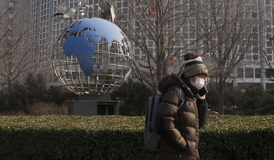 A woman walks by a globe sculpture displayed outside the Ministry of Foreign Affairs office in Beijing, Monday, Feb. 6, 2023. China on Monday accused the United States of indiscriminate use of force when the American military shot down a suspected Chinese spy balloon Saturday, saying that had &quot;seriously impacted and damaged both sides&#x27; efforts and progress in stabilizing Sino-U.S. relations.&quot; (AP Photo/Andy Wong)
