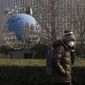 A woman walks by a globe sculpture displayed outside the Ministry of Foreign Affairs office in Beijing, Monday, Feb. 6, 2023. China on Monday accused the United States of indiscriminate use of force when the American military shot down a suspected Chinese spy balloon Saturday, saying that had &quot;seriously impacted and damaged both sides&#39; efforts and progress in stabilizing Sino-U.S. relations.&quot; (AP Photo/Andy Wong)