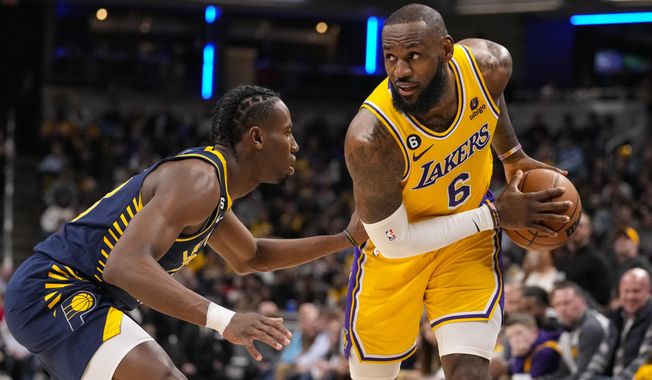Los Angeles Lakers forward LeBron James (6) is defended by Indiana Pacers forward Aaron Nesmith (23) during the first half of an NBA basketball game in Indianapolis, Thursday, Feb. 2, 2023. (AP Photo/Michael Conroy)