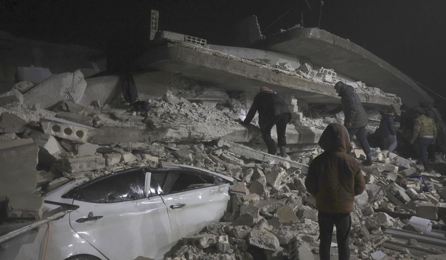 Syrian citizen search through the wreckage of a collapsed building, in Azmarin town, in Idlib province north Syria, Monday, Feb. 6, 2023. A powerful earthquake hit southeast Turkey and Syria early Monday, toppling buildings and sending panicked residents pouring outside in a cold winter night. (AP Photo/Ghaith Alsayed) **FILE**