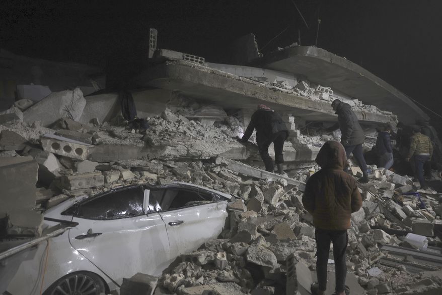 Syrian citizen search through the wreckage of a collapsed building, in Azmarin town, in Idlib province north Syria, Monday, Feb. 6, 2023. A powerful earthquake hit southeast Turkey and Syria early Monday, toppling buildings and sending panicked residents pouring outside in a cold winter night. (AP Photo/Ghaith Alsayed) **FILE**