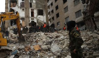 Civil defense workers and security forces search through the wreckage of collapsed buildings in Hama, Syria, Monday, Feb. 6, 2023. A powerful earthquake has caused significant damage in southeast Turkey and Syria and many casualties are feared. Damage was reported across several Turkish provinces, and rescue teams were being sent from around the country. (AP Photo/Omar Sanadik)