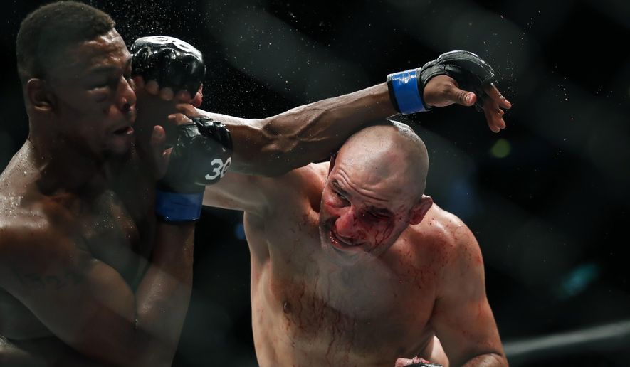Jamahal Hill, left, of the U.S., competes with Brazil&#x27;s Glover Teixeira in a light heavyweight title bout at the UFC 283 mixed martial arts fights in Rio de Janeiro, Brazil, Sunday, Jan. 22, 2023. (AP Photo/Bruna Prado)