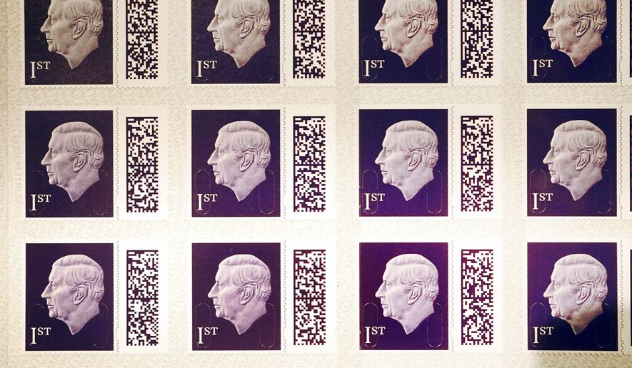 A view of a sheet of the 1st class definitive stamps featuring Britain&#x27;s King Charles III going on display at the Postal Museum in central London, before they enter circulation later this year, in London, Tuesday, Feb. 7, 2023. The image used of the King, which shows him facing to the left, is an adapted version of the portrait created by Martin Jennings for the Royal Mint for the obverse of the new UK coinage. (Victoria Jones/PA via AP)