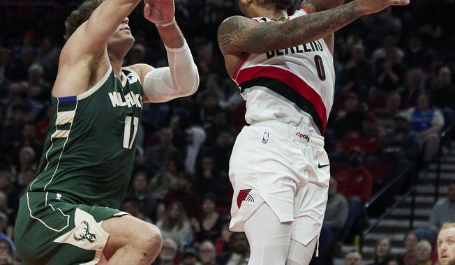Portland Trail Blazers guard Damian Lillard, right, shoots in front of Milwaukee Bucks center Brook Lopez during the first half of an NBA basketball game in Portland, Ore., Monday, Feb. 6, 2023. (AP Photo/Craig Mitchelldyer)