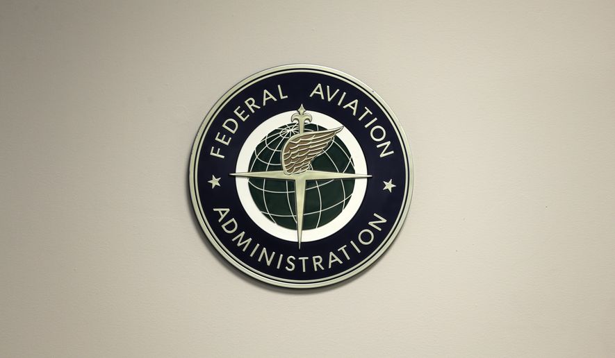A Federal Aviation Administration sign hangs in the tower at John F. Kennedy International Airport in New York, March 16, 2017.  Congress is taking up key aviation legislation just after close calls between planes at airports in New York and Texas. A House committee held the first hearing Tuesday, Feb. 7, 2023,  on legislation that will govern the Federal Aviation Administration.   (AP Photo/Seth Wenig, File)