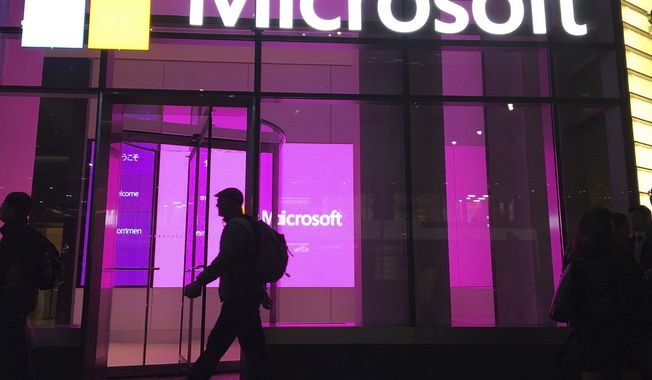People walk past a Microsoft office in New York on Nov. 10, 2016.  (AP Photo/Swayne B. Hall, File)