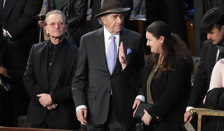 Bono, the Irish lead singer of U2, Paul Pelosi, husband of Rep. Nancy Pelosi, D-Calif., and Oksana Markarova, Ukrainian ambassador to the U.S., arrive in the first lady&#x27;s box in the House chamber before President Joe Biden delivers the State of the Union address to a joint session of Congress at the U.S. Capitol, Tuesday, Feb. 7, 2023, in Washington. (AP Photo/Patrick Semansky)