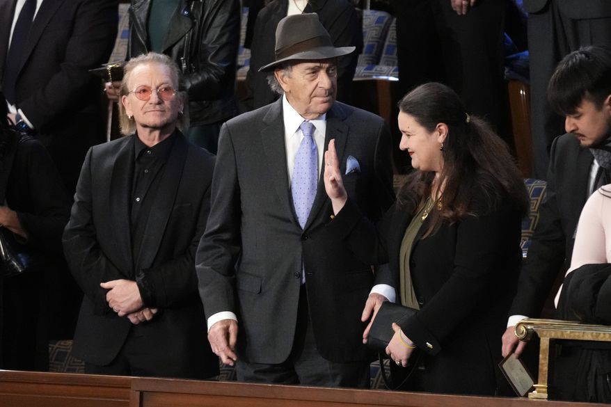 Bono, the Irish lead singer of U2, Paul Pelosi, husband of Rep. Nancy Pelosi, D-Calif., and Oksana Markarova, Ukrainian ambassador to the U.S., arrive in the first lady's box in the House chamber before President Joe Biden delivers the State of the Union address to a joint session of Congress at the U.S. Capitol, Tuesday, Feb. 7, 2023, in Washington. (AP Photo/Patrick Semansky)
