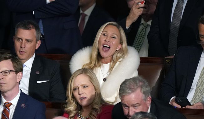 Rep. Majorie Taylor Greene, R-Ga., center, listens and reacts as President Joe Biden delivers his State of the Union speech to a joint session of Congress, at the Capitol in Washington, Tuesday, Feb. 7, 2023. (AP Photo/J. Scott Applewhite)