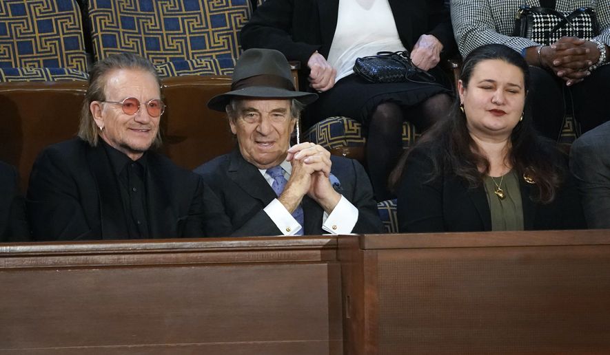 From left, Bono, Paul Pelosi and U.S. Ambassador to Ukraine, Marie Yovanovitch sit in the House Gallery together before President Joe Biden arrives to deliver his State of the Union speech to a joint session of Congress, at the Capitol in Washington, Tuesday, Feb. 7, 2023. (AP Photo/J. Scott Applewhite)