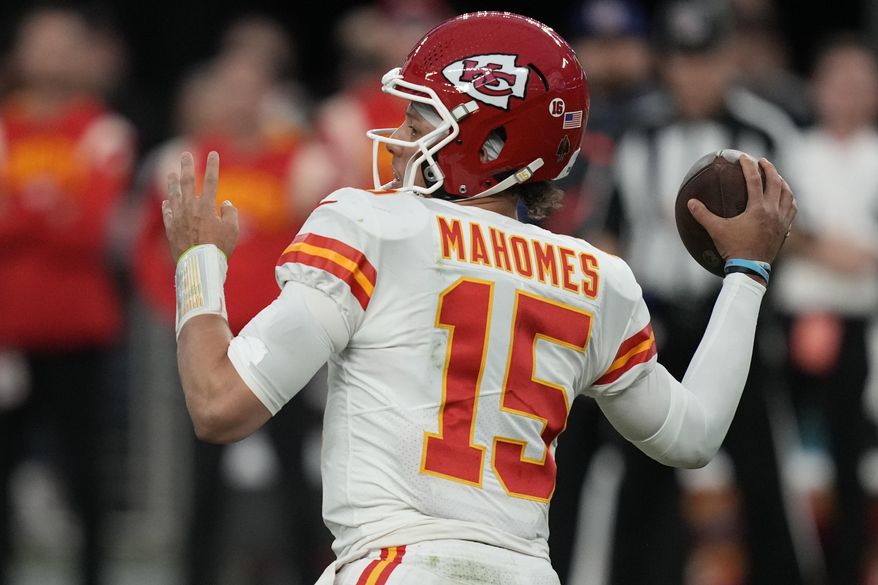 Kansas City Chiefs quarterback Patrick Mahomes (15) throws against the Las Vegas Raiders during the first half of an NFL football game, Wednesday, Jan. 11, 2023, in Las Vegas. The Chiefs and Eagles are bringing MVP finalists Patrick Mahomes and Jalen Hurts to the Super Bowl to cap a season in which the NFL had a glaring amount of instability at quarterback.(AP Photo/John Locher, File) **FILE**
