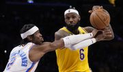 Los Angeles Lakers forward LeBron James, right, is fouled by Oklahoma City Thunder guard Shai Gilgeous-Alexander during the second half of an NBA basketball game Tuesday, Feb. 7, 2023, in Los Angeles. (AP Photo/Ashley Landis)
