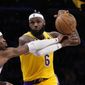 Los Angeles Lakers forward LeBron James, right, is fouled by Oklahoma City Thunder guard Shai Gilgeous-Alexander during the second half of an NBA basketball game Tuesday, Feb. 7, 2023, in Los Angeles. (AP Photo/Ashley Landis)