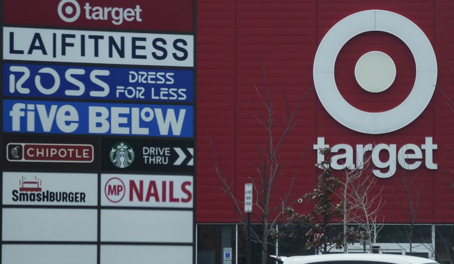 Business store signs are seen at a shopping center in Chicago, Tuesday, Feb. 7, 2022. (AP Photo/Nam Y. Huh)
