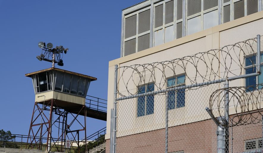 Barbed wire and a guard tower is seen at San Quentin State Prison on April 12, 2022, in San Quentin, Calif. California could reinstate voting rights to felons while they are in prison in a major expansion of suffrage for incarcerated people if a bill currently before the state legislature passes despite an uphill battle. (AP Photo/Eric Risberg,File)