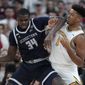 Georgetown center Qudus Wahab (34) tries to drive past Providence forward Ed Croswell (5) in the first half of an NCAA college basketball game, Wednesday, Feb. 8, 2023, in Providence, R.I. (AP Photo/Steven Senne)