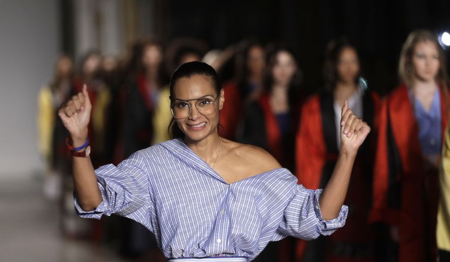 Designer Stella Jean accepts applause at the end of her women&#x27;s Spring/Summer 2018/19 fashion collection, presented in Milan, Italy, on Sept. 24, 2017. Stella Jean, the only Black designer belonging to Italy’s fashion council is withdrawing from this month’s Milan Fashion Week citing a lack of commitment to diversity and inclusion, and on Wednesday, Feb. 8, 2023, announced a hunger strike out of concern that other minority designers associated with her will suffer a backlash. (AP Photo/Luca Bruno, File)