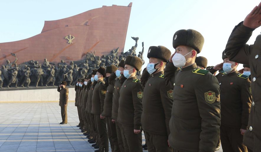 Public Security Forces soldiers salute to the statues of their late leaders Kim Il Sung and Kim Jong Il on the occasion of the 75th founding anniversary of the Korean People&#x27;s Army in Pyongyang, North Korea Wednesday, Feb. 8, 2023. (AP Photo/Jon Chol Jin)