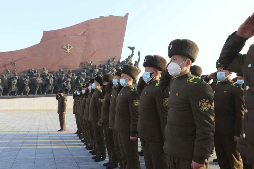 Public Security Forces soldiers salute to the statues of their late leaders Kim Il Sung and Kim Jong Il on the occasion of the 75th founding anniversary of the Korean People&#x27;s Army in Pyongyang, North Korea Wednesday, Feb. 8, 2023. (AP Photo/Jon Chol Jin)
