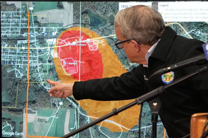 Ohio Gov. Mike DeWine points to a map of East Palestine, Ohio, that indicates the area that has been evacuated as a result of Norfolk Southern train derailment, after touring the site, Feb. 6, 2023, in East Palestine, Ohio. After toxic chemicals were released into the air from a wrecked train in Ohio, evacuated residents remain in the dark about what toxic substances are lingering in their vacated neighborhoods while they await approval to return home. (AP Photo/Gene J. Puskar)