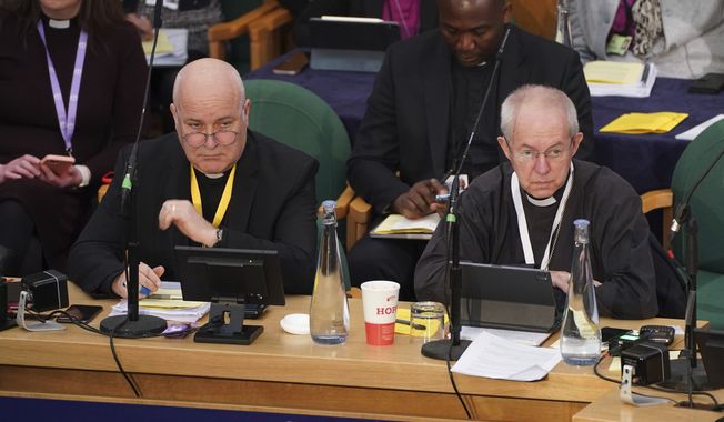 The Archbishop of York, Stephen Cottrell, left and The Archbishop of Canterbury, Justin Welby, gather at the General Synod of the Church of England, at Church House to consider a motion which reviews the church&#x27;s failure &quot;to be welcoming to LGBTQI+ people&quot; and the harm they have faced and still experience, in London, Thursday, Feb. 9, 2023. (James Manning/PA via AP)
