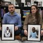 Bryan and Julie Hanlon hold photos of their adopted Haitian children, Gina, left, and Peterson, in a play area of their home in Washington, Tuesday, Feb. 7, 2023. They became the legal parents of the siblings in 2022 and fear they won&#x27;t be able to secure their passports and fly them out of Haiti. (AP Photo/Cliff Owen)