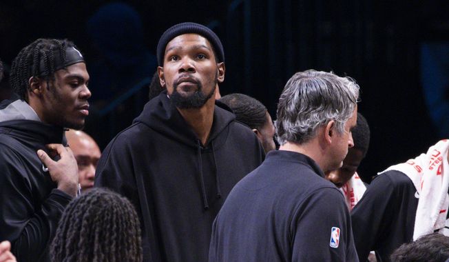 Brooklyn Nets forward Kevin Durant, center, looks on from the bench during the second half of an NBA basketball game against the Los Angeles Lakers, Monday, Jan. 30, 2023, in New York. (AP Photo/Corey Sipkin) **FILE**