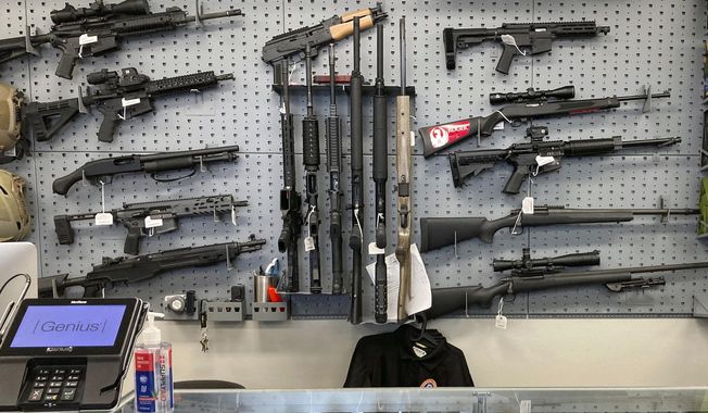 Firearms are displayed at a gun shop in Salem, Ore., Feb. 19, 2021. In a ruling Thursday, Feb. 9, 2023, the Oregon Supreme Court again refused to overturn a lower court ruling blocking a voter-approved gun measure from taking effect. Voters in November 2022 narrowly approved the measure, which requires a permit to buy a gun and a background check to be completed before a gun can be sold or transferred. It also restricts the sale, manufacture and use of magazines holding more than 10 rounds of ammunition. (AP Photo/Andrew Selsky) **FILE**