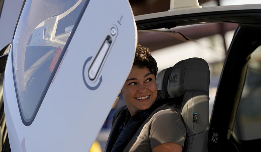 United Aviate Academy student pilot Ashley Montano inspects her aircraft prior to a flight, Friday, Oct. 28, 2022, in Goodyear, Ariz. Montano hopes that in a few years she will be flying airline jets. If she does, she'll be helping solve a critical problem facing the industry: not enough pilots. (AP Photo/Matt York)