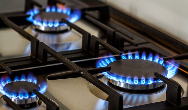 Natural gas burning on kitchen gas stove in the dark. File photo credit: Bilanol via Shutterstock