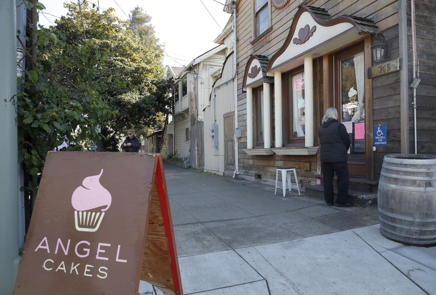 Customers enter the Angel Cakes bakery on 5th Street in Oakland, Calif., Thursday, Feb. 9, 2023. Owner Jen Angel died Thursday from injuries she sustained after being dragged more than 50 feet by a car carrying thieves who had robbed her in downtown Oakland on Monday, Feb. 6. (Jane Tyska/Bay Area News Group via AP)