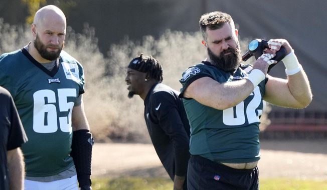 Philadelphia Eagles center Jason Kelce (62) and offensive tackle Lane Johnson (65) warm up during an NFL football Super Bowl team practice, Wednesday, Feb. 8, 2023, in Tempe, Ariz. The Eagles will face the Kansas City Chiefs in Super Bowl 57 Sunday. (AP Photo/Matt York)