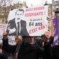 A protester holds a placard reading &quot;Go To Work Lazy, Your Pension at 64years Old, It Is NO&quot; during a demonstration against plans to push back France&#x27;s retirement age, in Paris, Saturday, Feb. 11, 2023. France is bracing itself for a fourth round of nationwide protests against President Emmanuel Macron&#x27;s plans to reform pensions but key transports unions have not called for strikes allowing trains and the Paris metro to run this time. (AP Photo/Michel Euler)