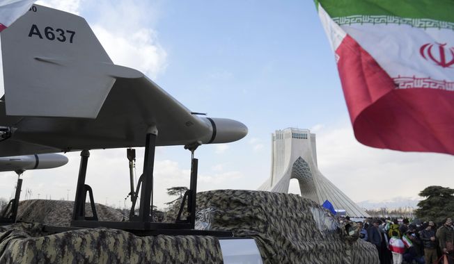 An Iranian domestically built drone is displayed during the annual rally commemorating Iran&#x27;s 1979 Islamic Revolution, with Azadi (Freedom) monument tower seen in the background, in Tehran, Iran, Saturday, Feb. 11, 2023. (AP Photo/Vahid Salemi) ** FILE **