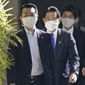 Japanese Prime Minister Fumio Kishida, center, arrives at a hospital in Tokyo Saturday, Feb. 11, 2023. Kishida is having sinus surgery at a Tokyo hospital on Saturday to treat chronic sinusitis that has caused him to have a stuffy nose since last year. (Kyodo News via AP)