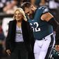 First lady Jill Biden talks with Philadelphia Eagles center Jason Kelce (62) before the coin toss before an NFL football game against the Dallas Cowboys, Oct. 16, 2022, in Philadelphia. (AP Photo/Rich Schultz, File)