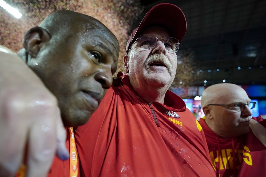 Kansas City Chiefs head coach Andy Reid, middle, and offensive coordinator Eric Bieniemy, left, celebrate victory over the Philadelphia Eagles after the NFL Super Bowl 57 football game, Sunday, Feb. 12, 2023, in Glendale, Ariz. The Kansas City Chiefs defeated the Philadelphia Eagles 38-35. (AP Photo/Brynn Anderson)