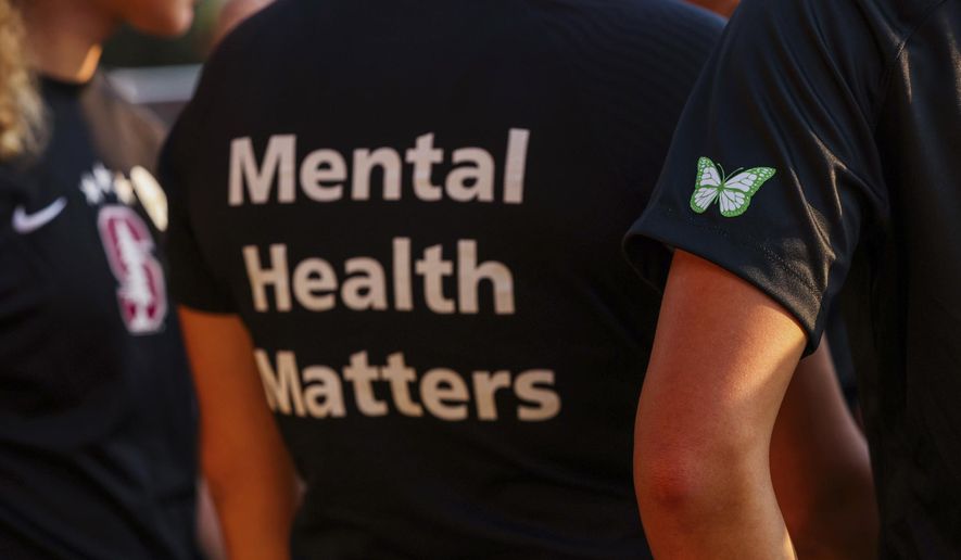 Stanford women's soccer team players wear warmup jerseys with "Mental Health Matters" on their backs as well as a butterfly patch on their sleeves to remember late goalie Katie Meyer, who died by suicide earlier in the year, before an NCAA college soccer match against UCLA, Oct. 14, 2022, in Stanford, Calif. The COVID-19 pandemic took an especially harsh toll on U.S. teen girls’ mental health, with almost 60% reporting feelings of persistent sadness or hopelessness, according to a government survey released Monday, Feb. 13, 2023, that bolsters earlier data. (Yalonda M. James/San Francisco Chronicle via AP, File)
