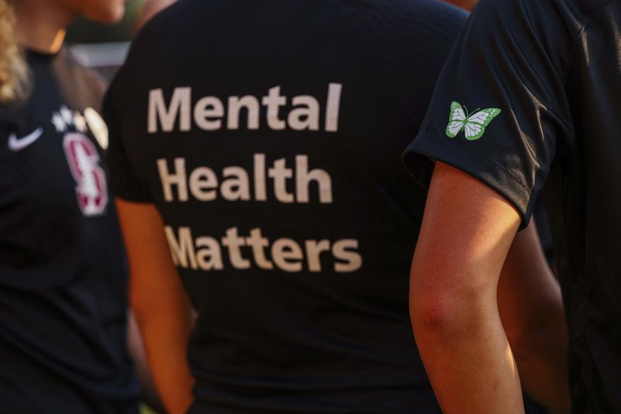 Stanford women's soccer team players wear warmup jerseys with "Mental Health Matters" on their backs as well as a butterfly patch on their sleeves to remember late goalie Katie Meyer, who died by suicide earlier in the year, before an NCAA college soccer match against UCLA, Oct. 14, 2022, in Stanford, Calif. The COVID-19 pandemic took an especially harsh toll on U.S. teen girls’ mental health, with almost 60% reporting feelings of persistent sadness or hopelessness, according to a government survey released Monday, Feb. 13, 2023, that bolsters earlier data. (Yalonda M. James/San Francisco Chronicle via AP, File)