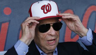 In this Feb. 28, 2017, file photo, Washington Nationals owner Ted Lerner tries on a baseball cap before a ribbon cutting ceremony to open The Ballpark in West Palm Beach, Fla. Washington Nationals founder Ted Lerner has died. He was 97. Lerner bought the team from Major League Baseball in 2006 for $450 million. He was managing principal owner until ceding that role to son Mark in 2018. (AP Photo/John Bazemore, File)