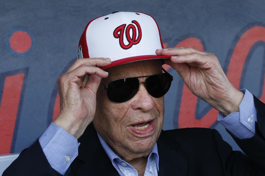 In this Feb. 28, 2017, file photo, Washington Nationals owner Ted Lerner tries on a baseball cap before a ribbon cutting ceremony to open The Ballpark in West Palm Beach, Fla. Washington Nationals founder Ted Lerner has died. He was 97. Lerner bought the team from Major League Baseball in 2006 for $450 million. He was managing principal owner until ceding that role to son Mark in 2018. (AP Photo/John Bazemore, File) **FILE**