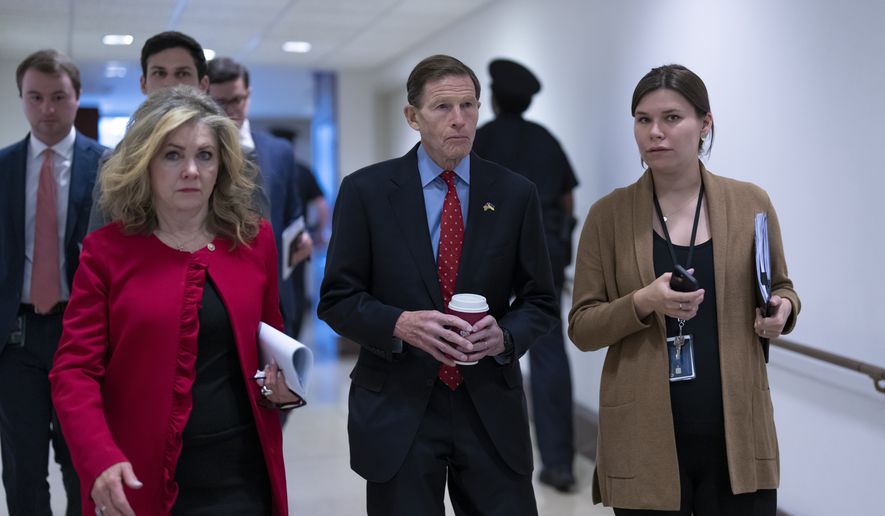 Sen. Marsha Blackburn, R-Tenn., left, and Sen. Richard Blumenthal, D-Conn., head to a secure area as lawmakers and intelligence advisers arrive for a closed briefing on the unknown aerial objects the U.S. military shot down this weekend at the Capitol in Washington, Tuesday, Feb. 14, 2023. The incidents come shortly after a Chinese surveillance balloon traversed the U.S. and was shot down off South Carolina a week ago. (AP Photo/J. Scott Applewhite)