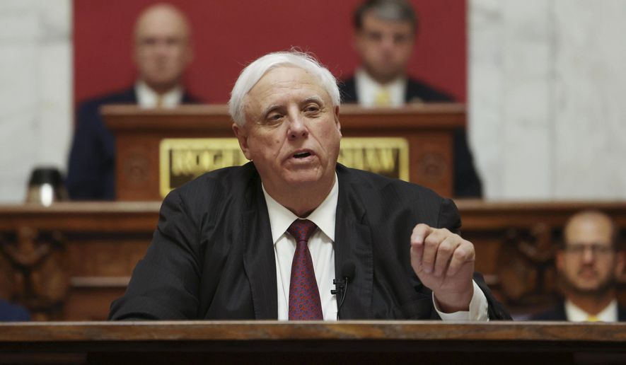 West Virginia Gov. Jim Justice delivers his annual State of the State address in the House Chambers at the state capitol in Charleston, W.Va., on Jan. 11, 2023. The House of Delegates passed a bill Tuesday, Feb. 14, 2023, that would split the Department of Health and Human Resources into three new departments. Justice last year vetoed a bill passed by lawmakers that would have split the agency into two parts. (AP Photo/Chris Jackson, File)
