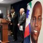 An image of Haitian President Jovenel Moïse, right, is displayed as Markenzy Lapointe, U.S. Attorney for the Southern District of Florida, speaks speaks during a news conference, Tuesday, Feb. 14, 2023, in Miami. U.S. authorities have arrested four more people in the slaying of Moïse, including the owner of a Miami-area security company that hired former soldiers from Colombia for the mission. (AP Photo/Lynne Sladky)