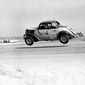 Red Farmer (61) goes airborne after hitting a hole on the four-mile Daytona Beach road course during the 100-mile Modified and Sportsmen type stock car race in Daytona Beach, Fla., Feb. 14, 1953. NASCAR marks its 75th year in 2023, recalling both its highs and lows. (AP Photo/James P. Kerlin, File)